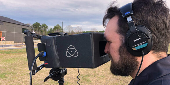 Ben Park of Kino Mountain Productions looks into a camera viewfinder.