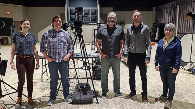 The Kino Mountain Productions video production team surrounded by camera equipment.